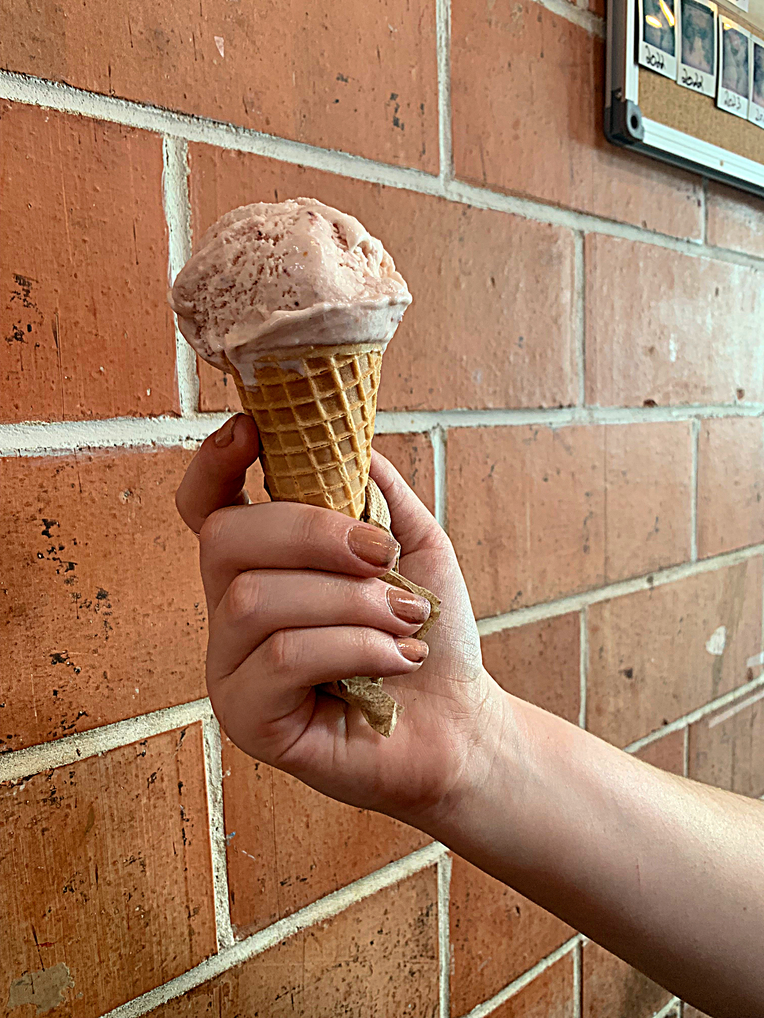 An Ice cream cone against a brick background (One-Day Itinierary in Austin)