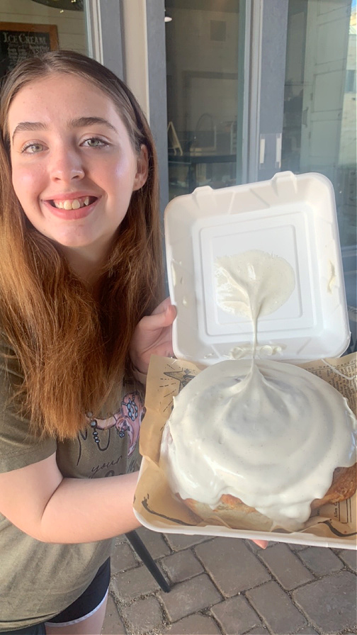 Breanna with a giant cinnamon roll