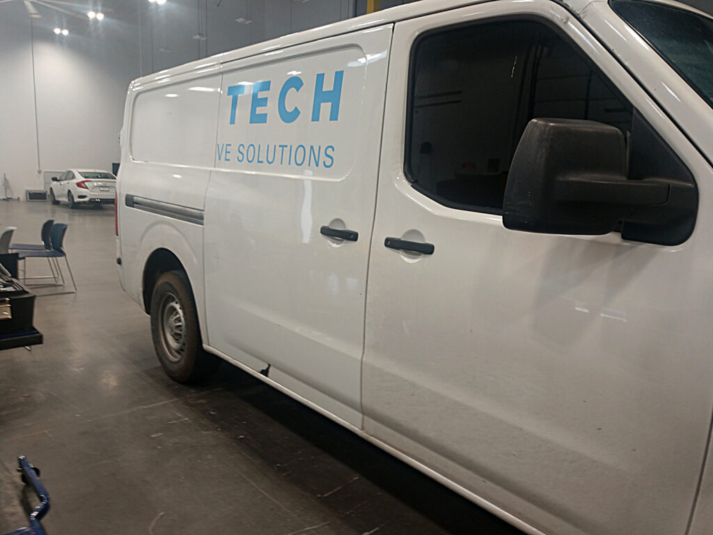 Letters being peeled off an old work van