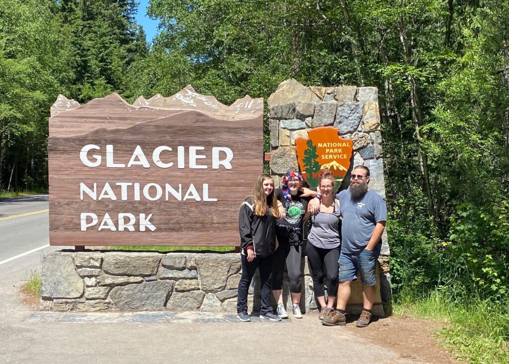 A Family Picture in front of Glacier National Park sign