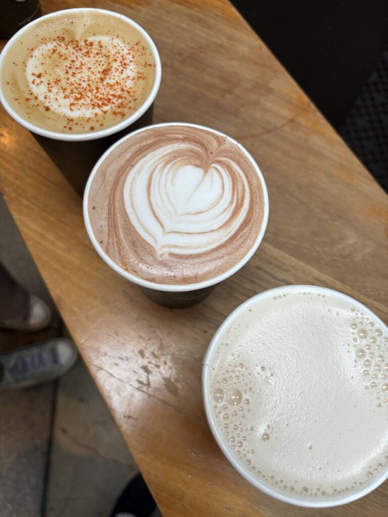 Top view of three coffees on a wooden board