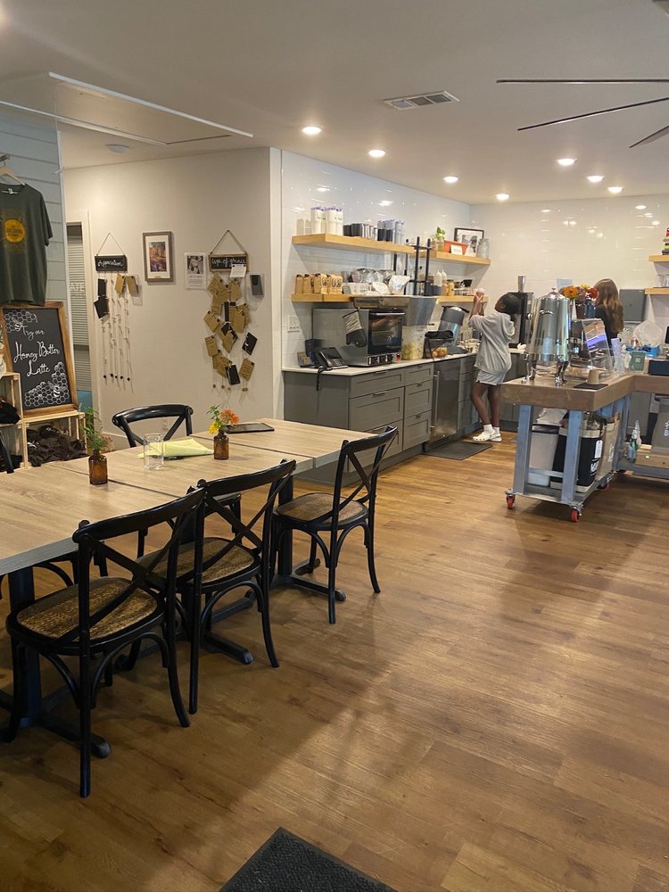 A coffee shop with a table and chairs in the foreground.