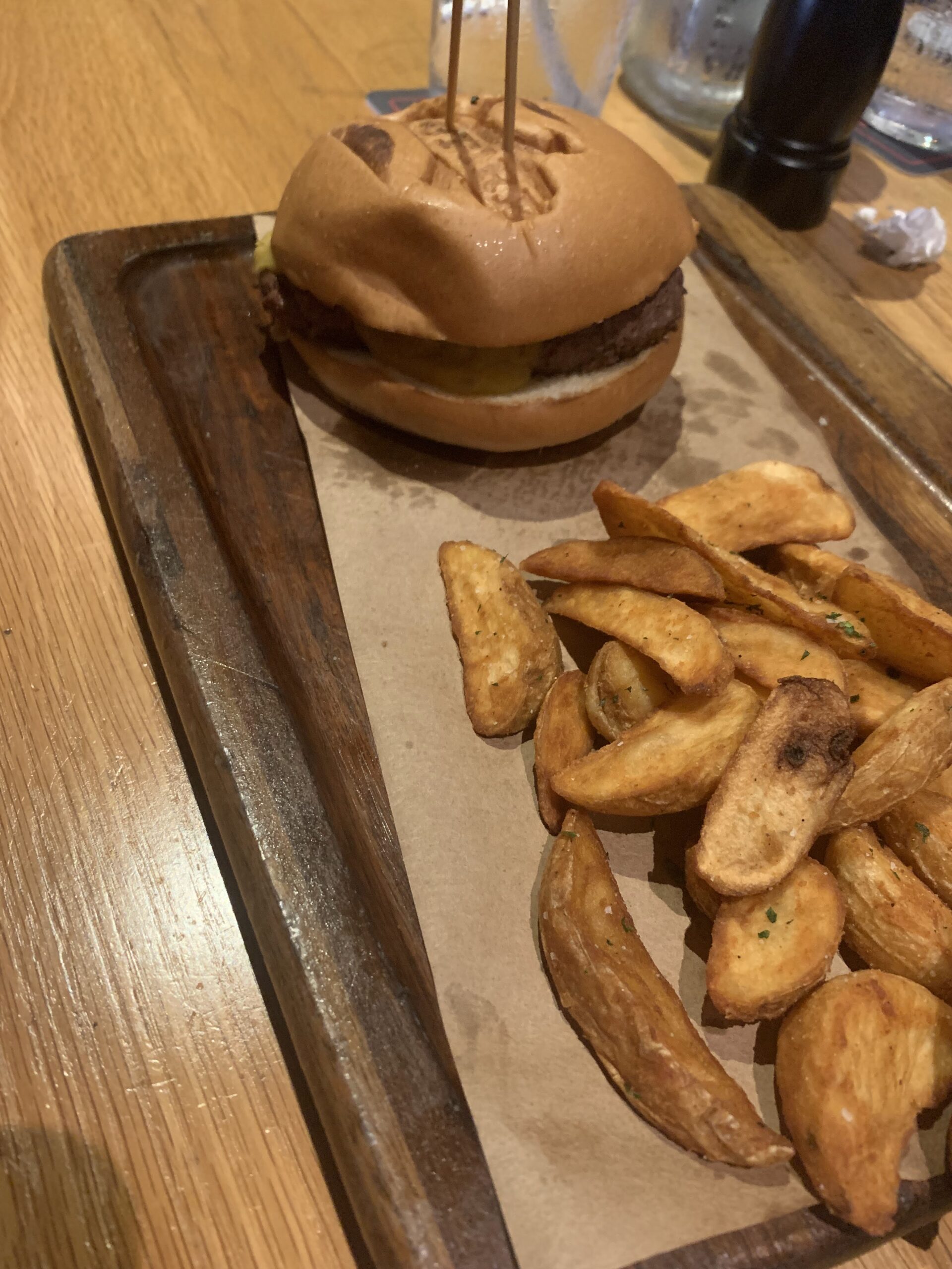 Branded bread burger and fries on a black board