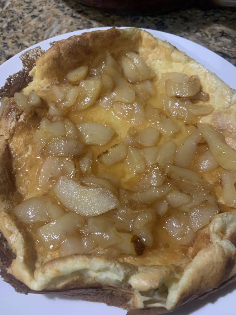 A dutch baby with pears inside