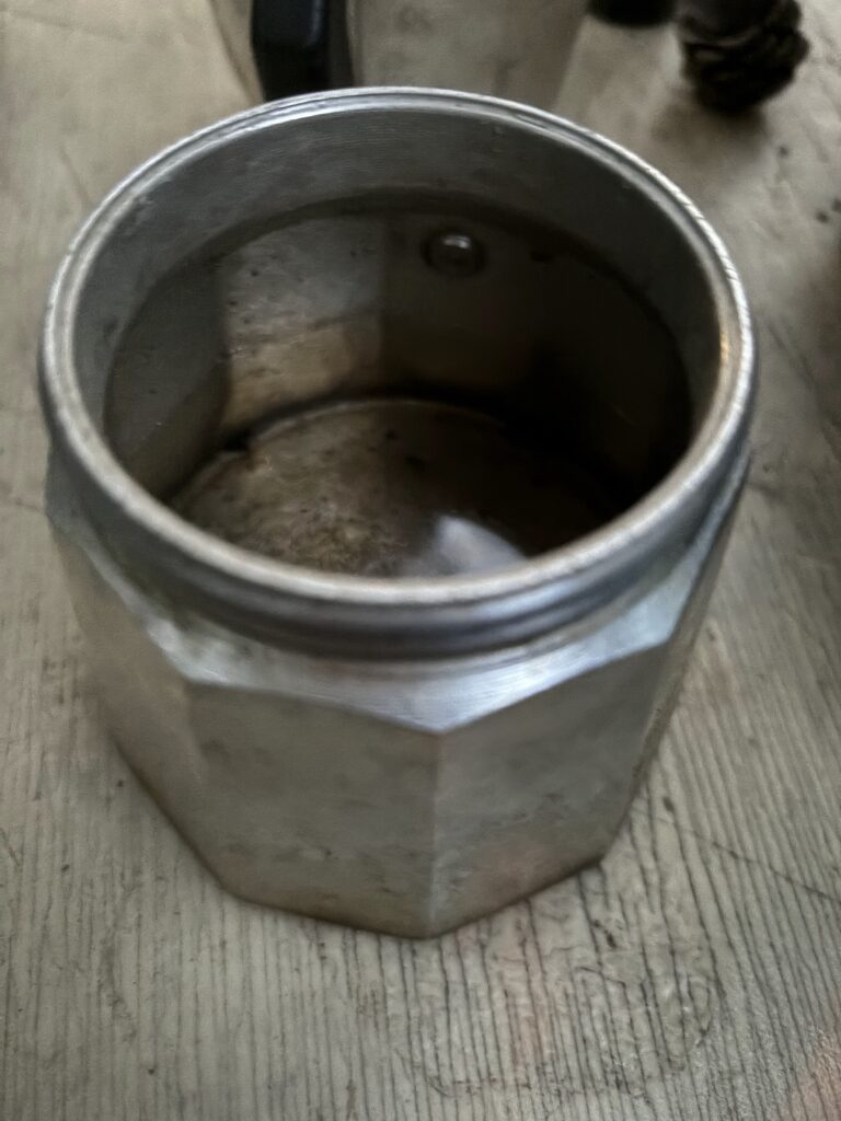 Bottom of a moka pot with water in it