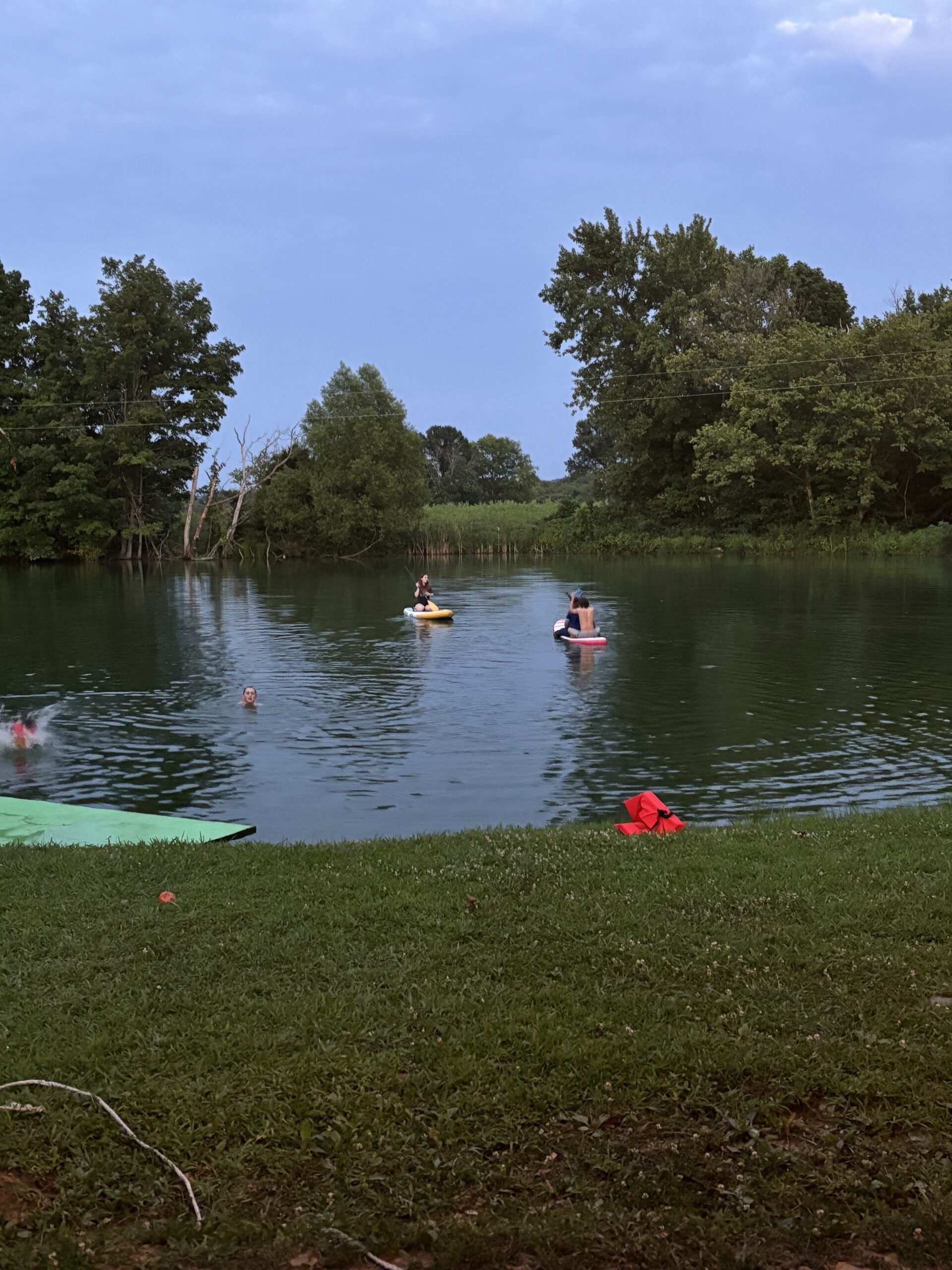 Two kids playing in a pond