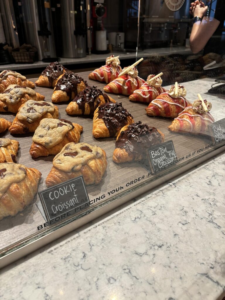 Four different types of croissants with tags in front of them