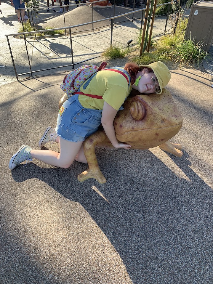 A girl hugging a frog