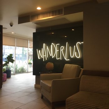 Wanderlust sign lit up in a building