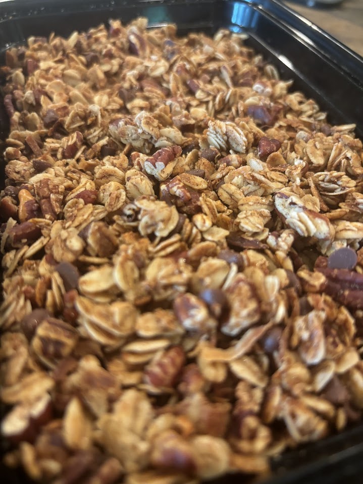 Cooled down granola in container with chocolate chips