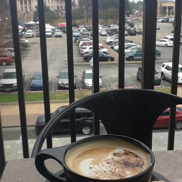 A cup of coffee overlooking a farmers market