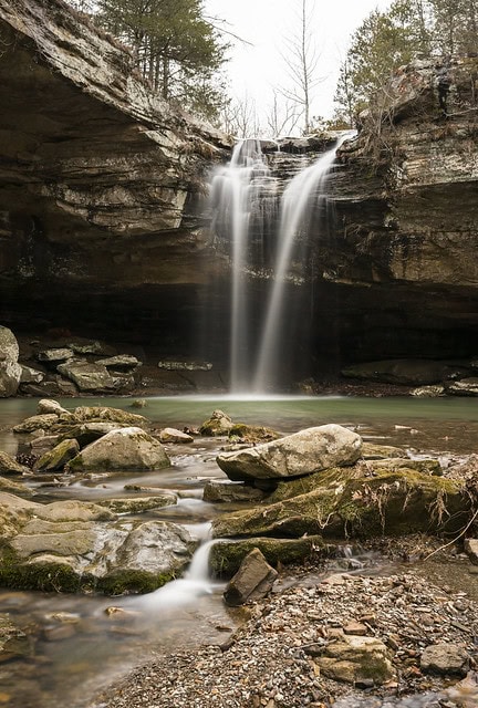 A waterfall that ends in a pool of water