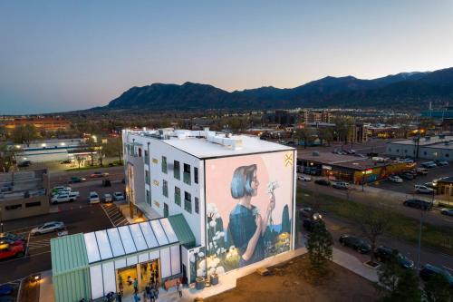 The outside of Kingship Landing with a mural of a lady on it