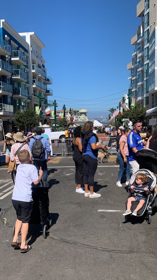 A view of the ocean with buildings in between at Little Italy Mercato in San Diego