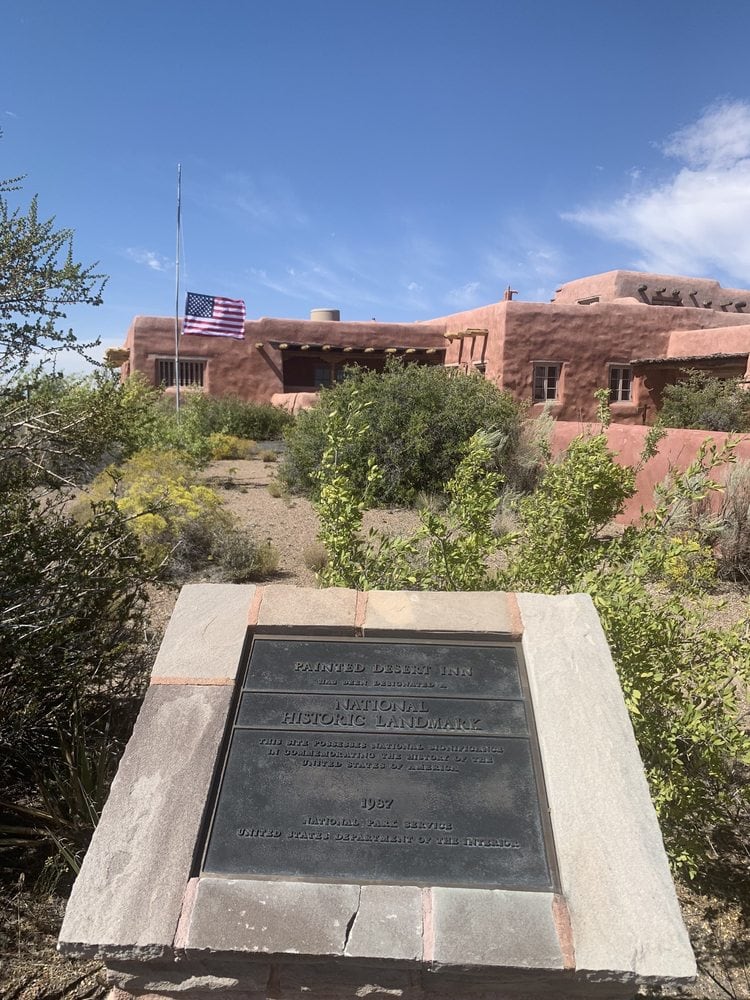 A sign talking about the Painted Desert Inn and the building behind it