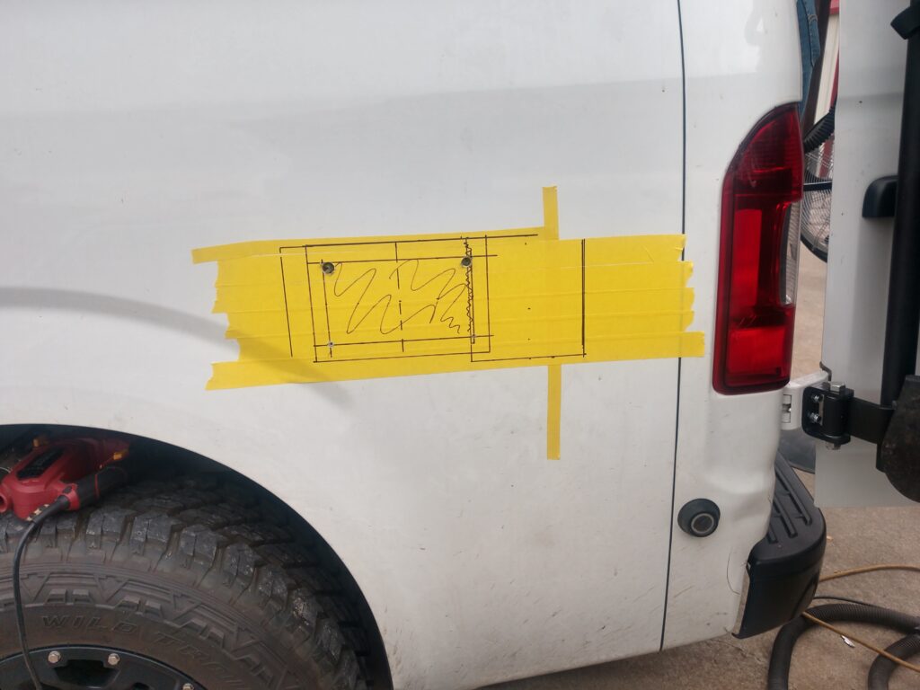 A cut out diagram where the water system is going to go on a van