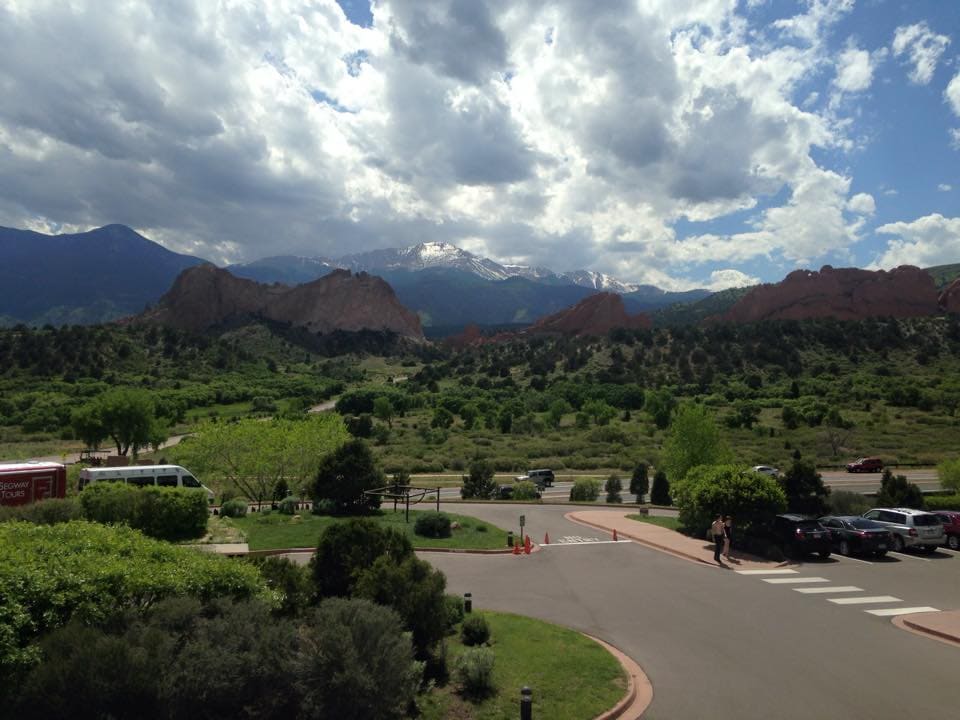 A road, greenery, and mountains