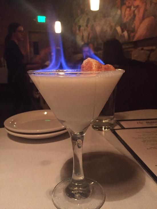 A margarita drink with marshmallows and flames coming off it