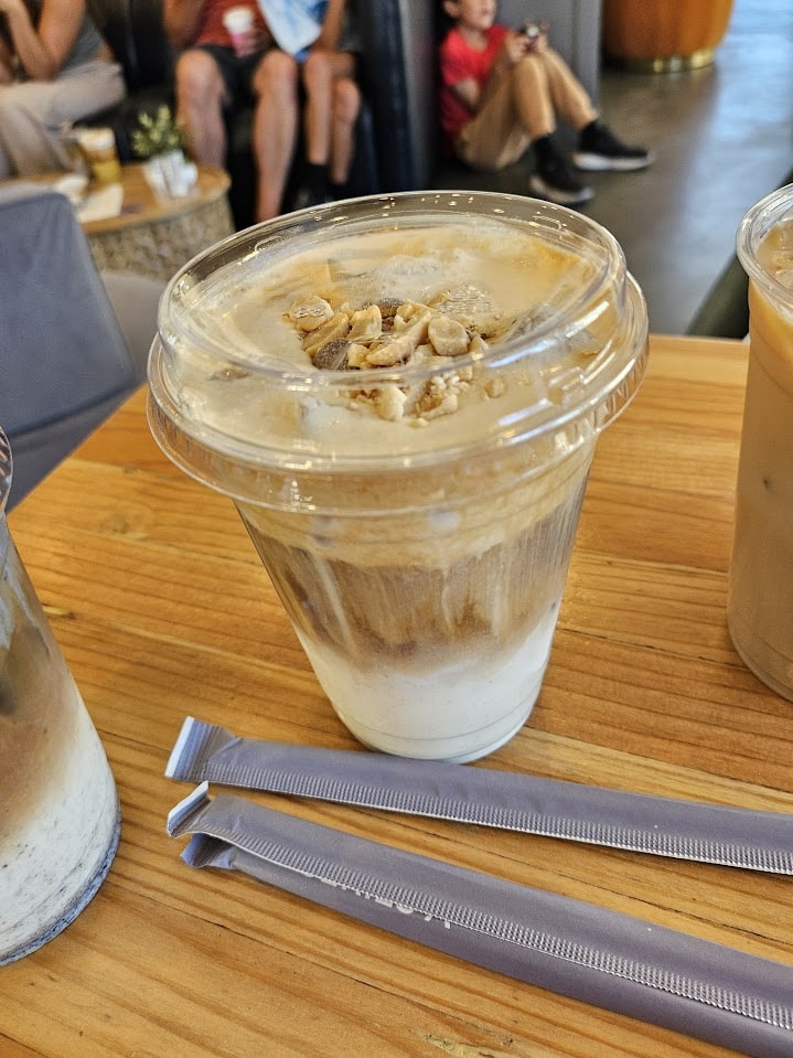 An iced coffee that you can see the syrup draining down into.