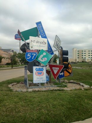 A bunch of signs in front of a hotel