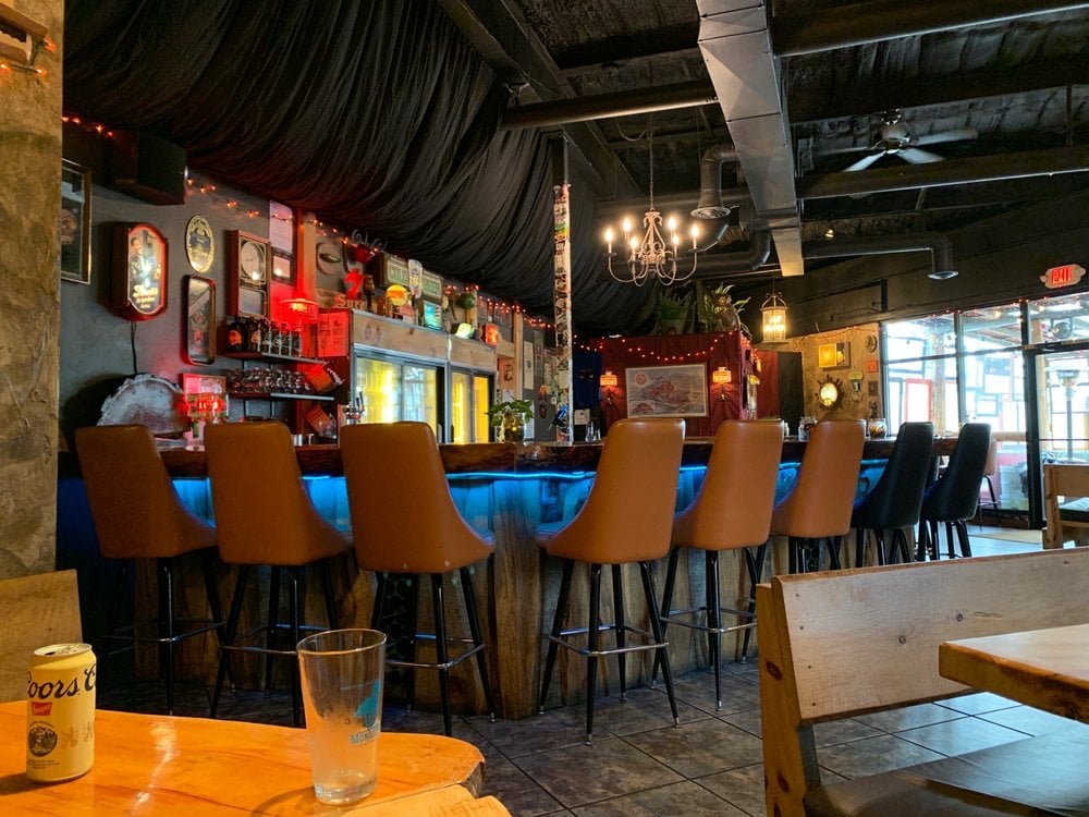 A bar with yellow chairs 