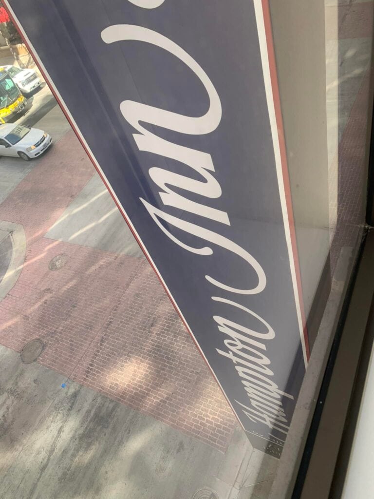 A sign that says "Hampton Inn" from outside a window