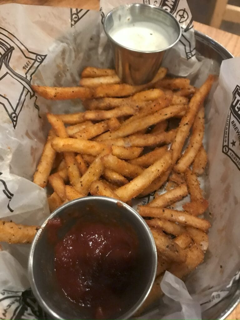 An order of Beer battered fries with ketchup and ranch