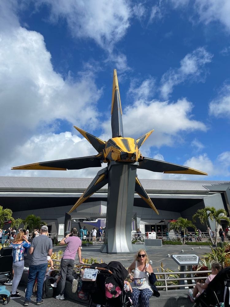 The outside area of the cosmic rewind ride with a yellow ship statue