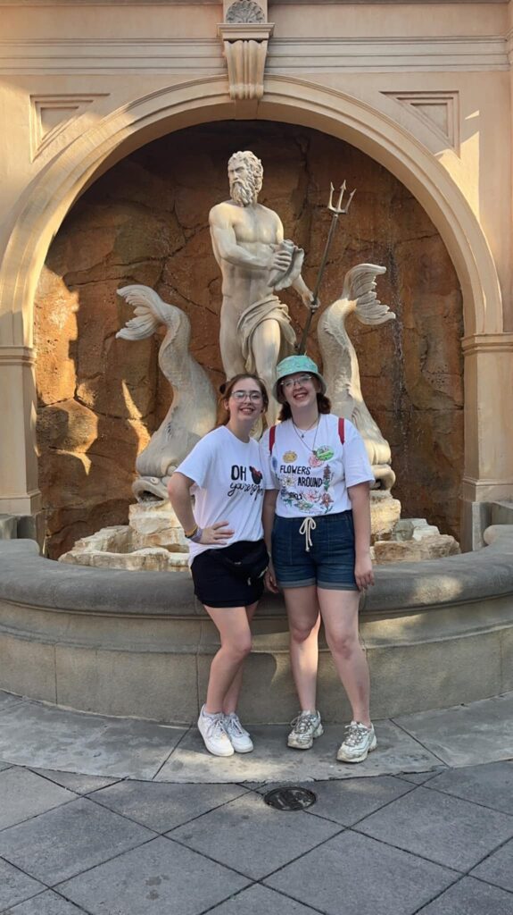 Two girls standing in front of a fountain in the Italy pavilion at Epcot