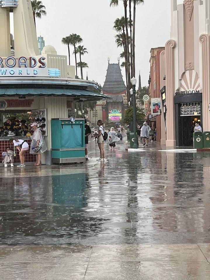 A wet Hollywood Boulevard with Mickey and Minnie's Runaway Railway in the distance