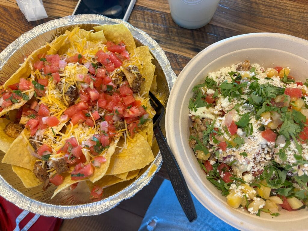 Two bowls side by side. one has nacho, the other has burrito 